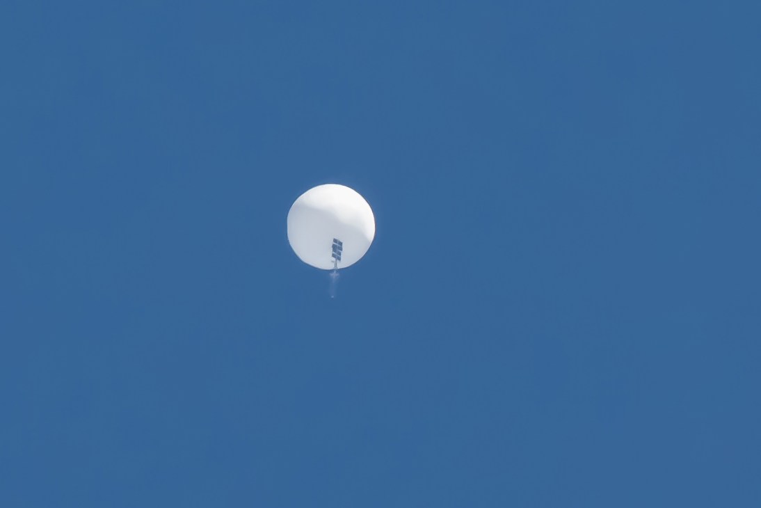 White balloon floating against clear blue sky