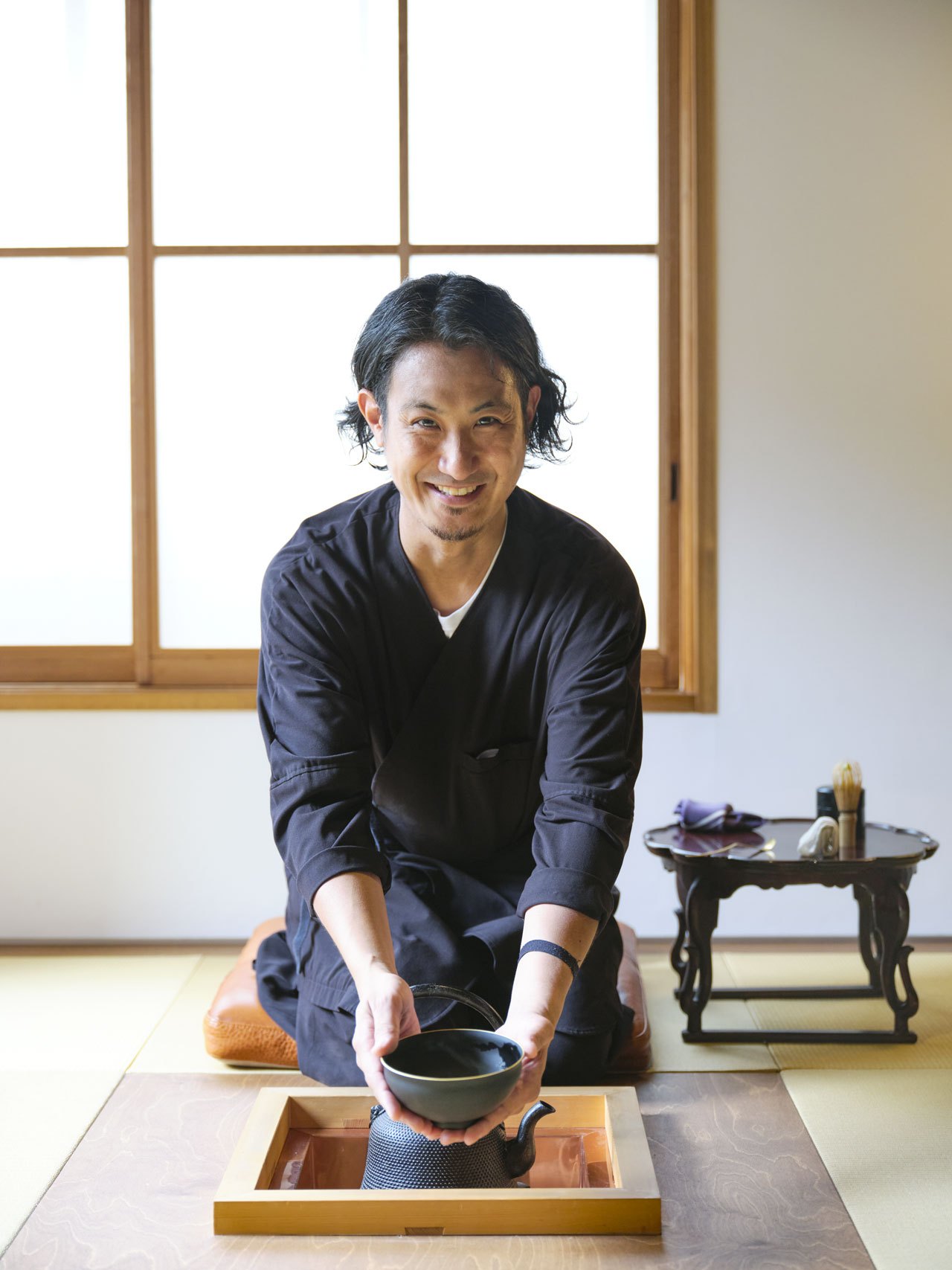 Yusuke Mori, butler at Trunk House inn in Tokyo, preparing tea in traditional Japanese room