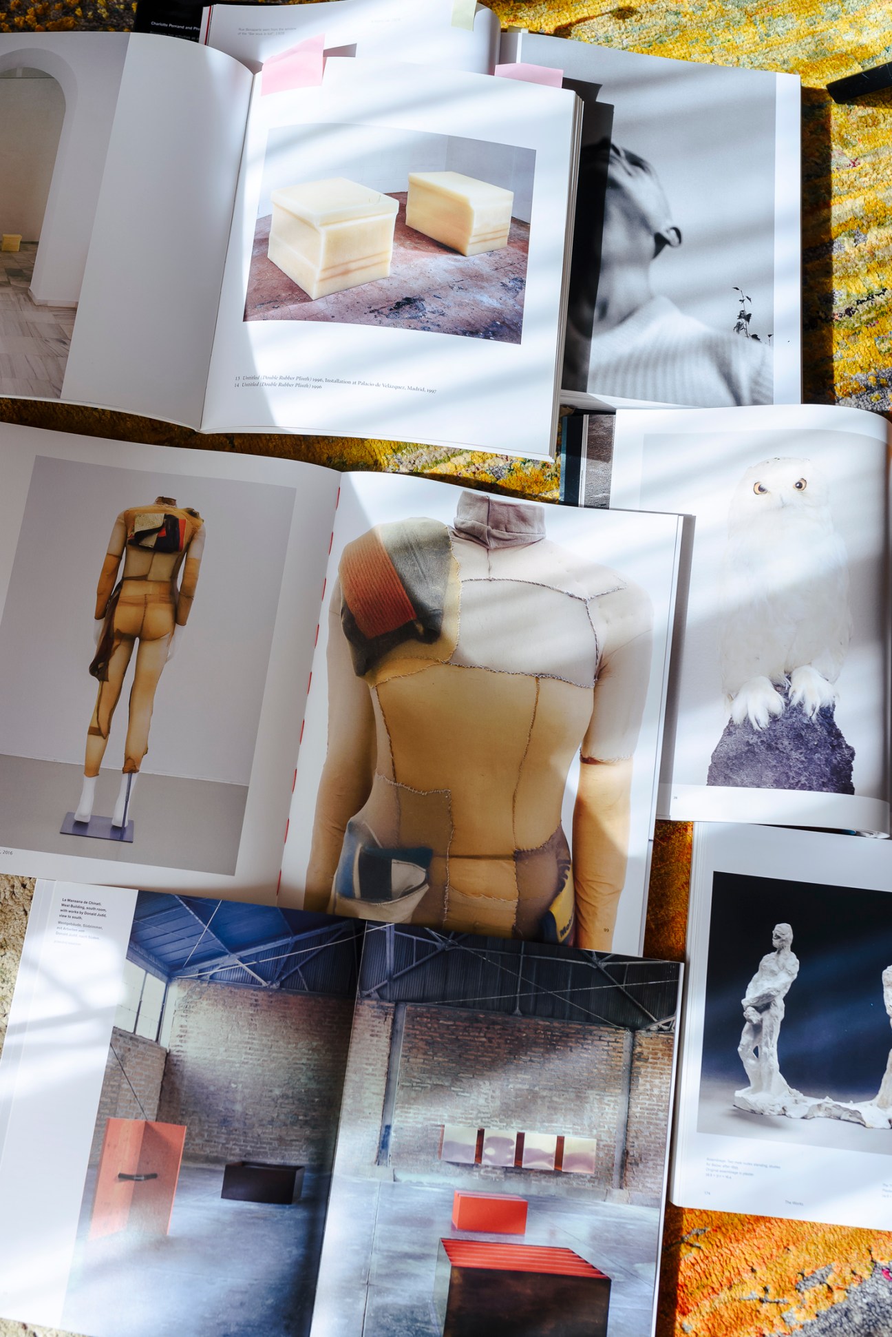 Designer Damir Doma's mood board featuring fabric swatches, sketches, and inspiration materials on work table
