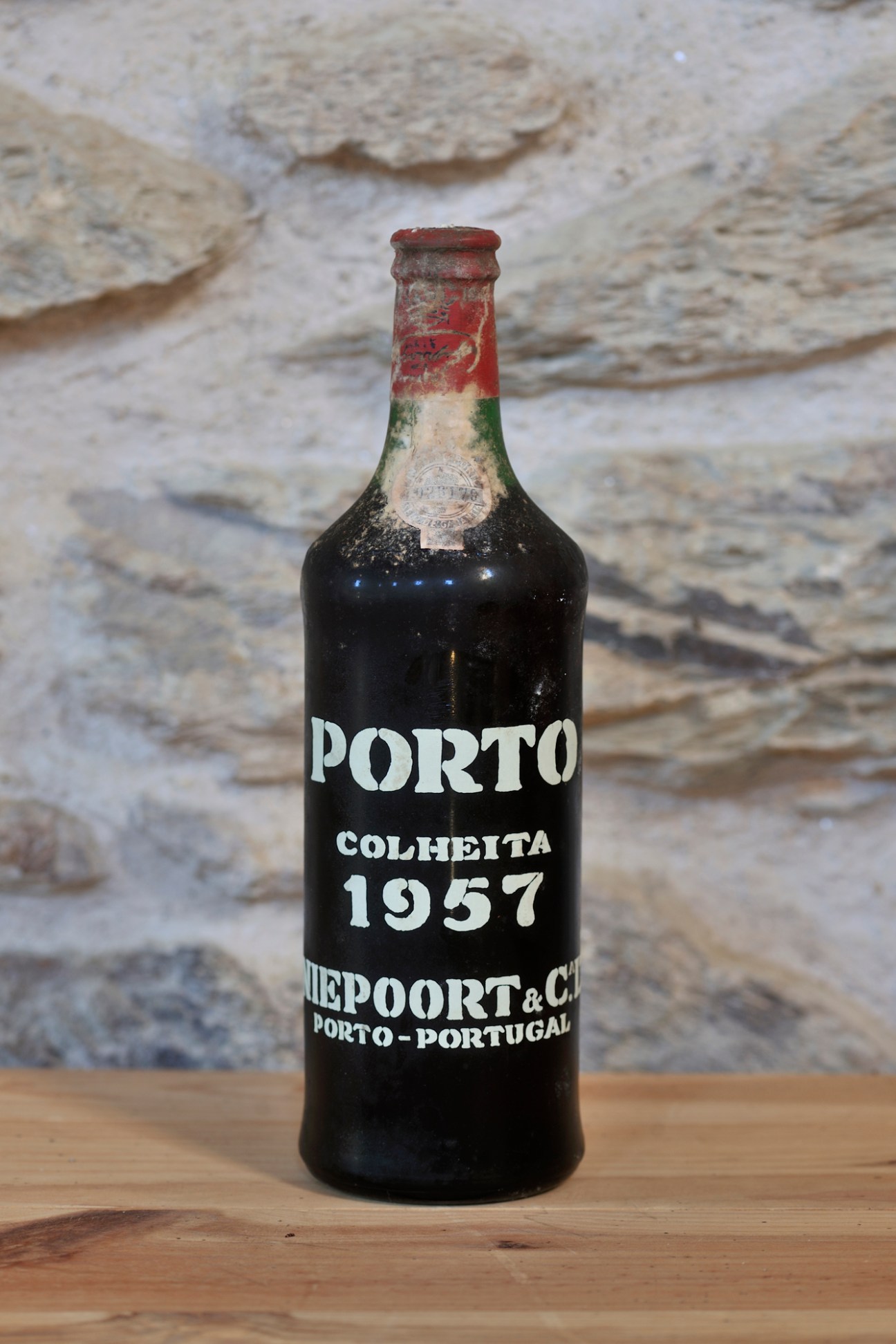 Vintage 1957 Porto Colheita bottle from Niepoort showing aged label and weathered foil capsule