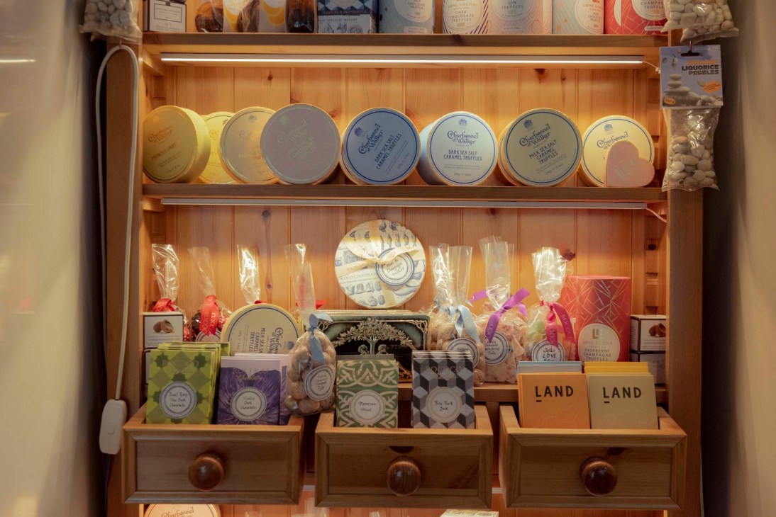 Close-up of deli counter at De Beauvoir Deli Co. displaying fresh prepared foods and charcuterie