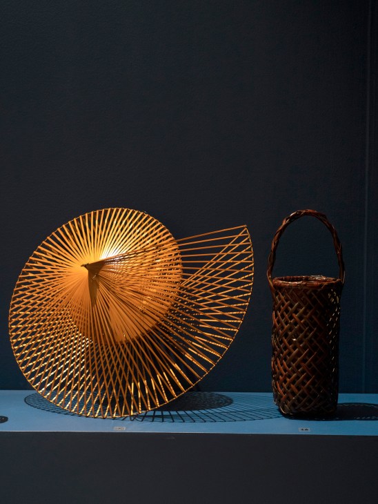 Woven bamboo baskets displayed on white surface against dark background