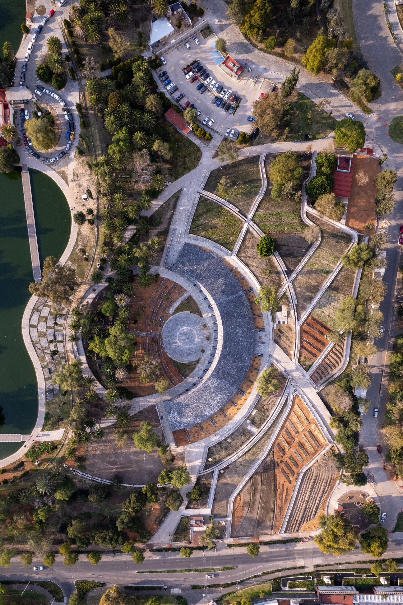 Aerial view of Environmental Culture Center's spiraling botanical pavilion with curved walkways in Bosque de Chapultepec