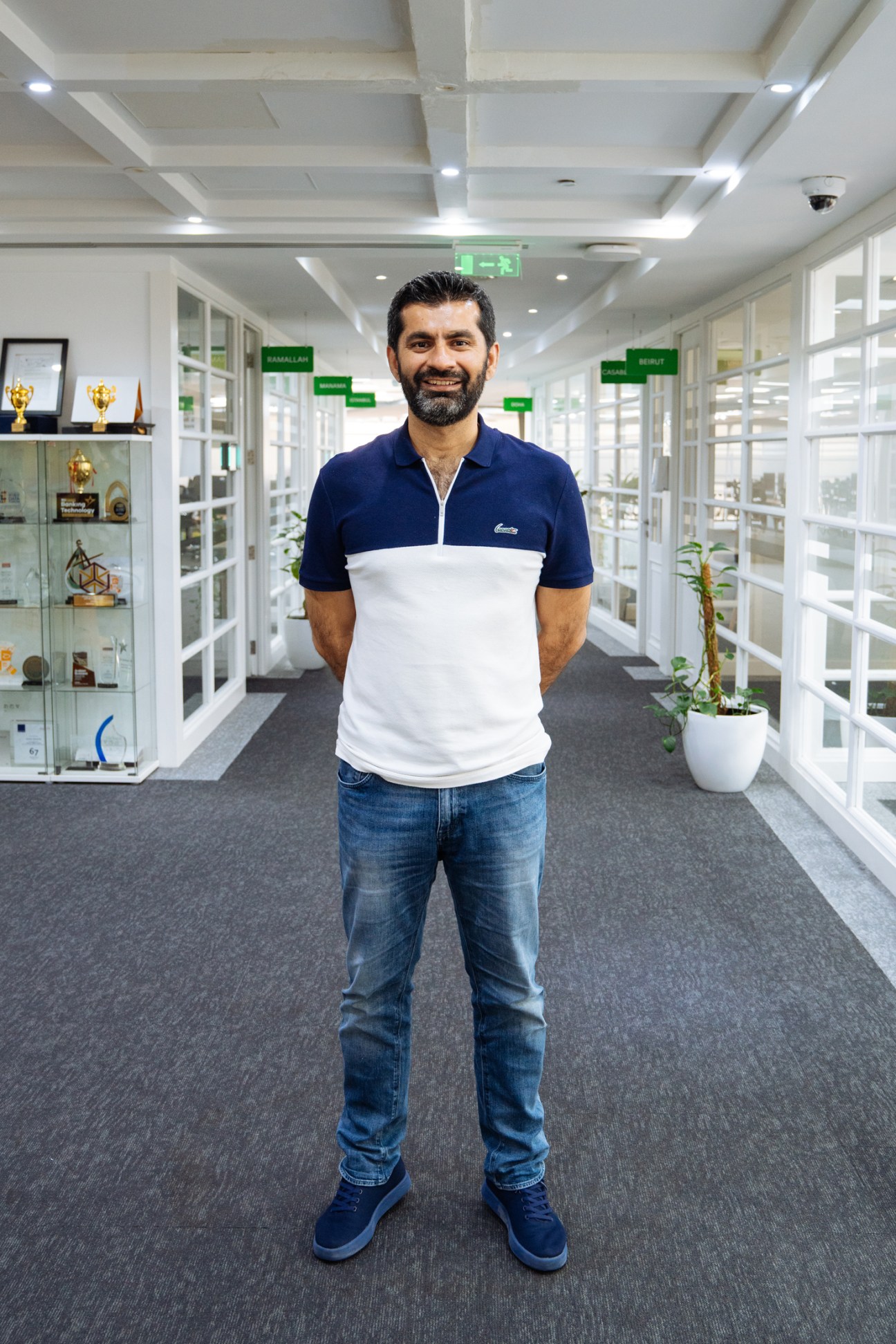 Mudassir Sheikha, co-founder and CEO of Careem, standing in a corridor at the company's headquarters.