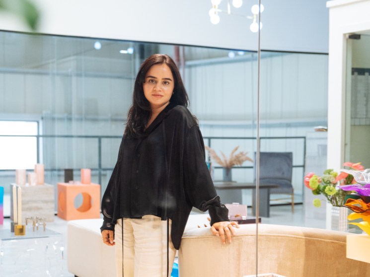 Lilian Afshar stands in her modern Dubai studio workshop, surrounded by acrylic handbags and accessories