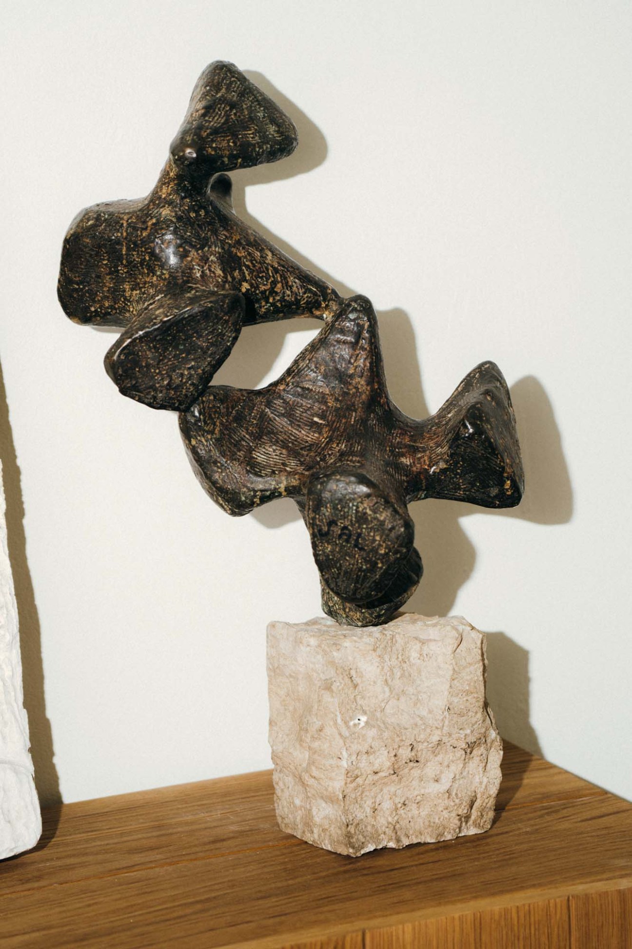 Abstract bronze sculpture by Italian artist Claudio Trevi on limestone base