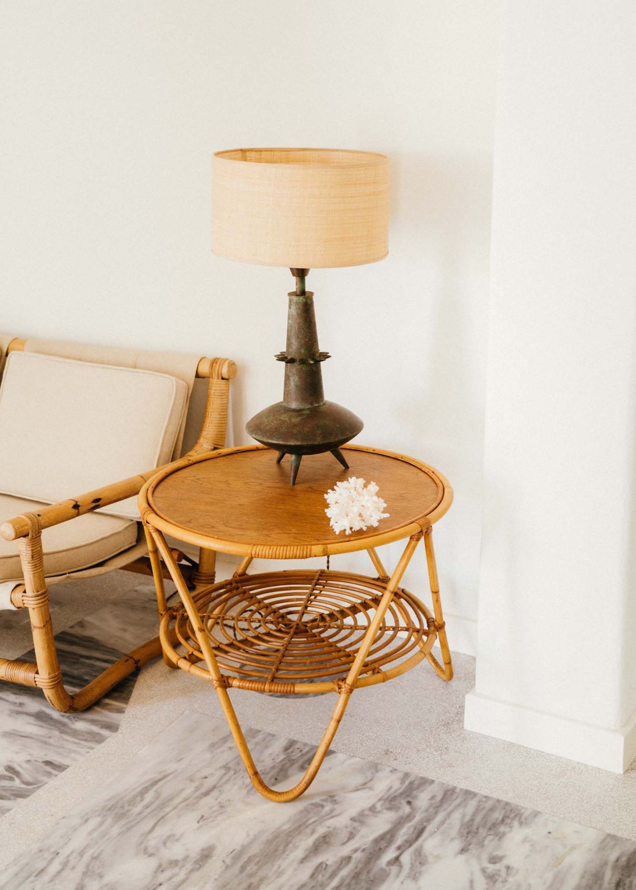 Vintage metal pendant lamp with linen shade on wooden side table in renovated apartment