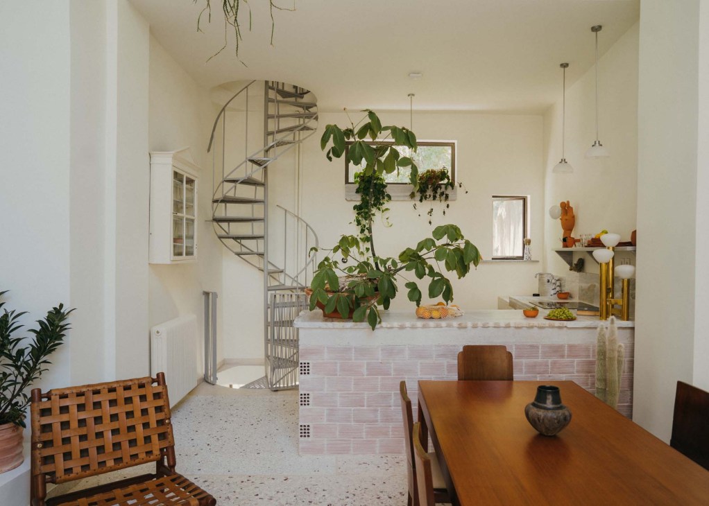 Curved original wooden spiral staircase in renovated Athens apartment