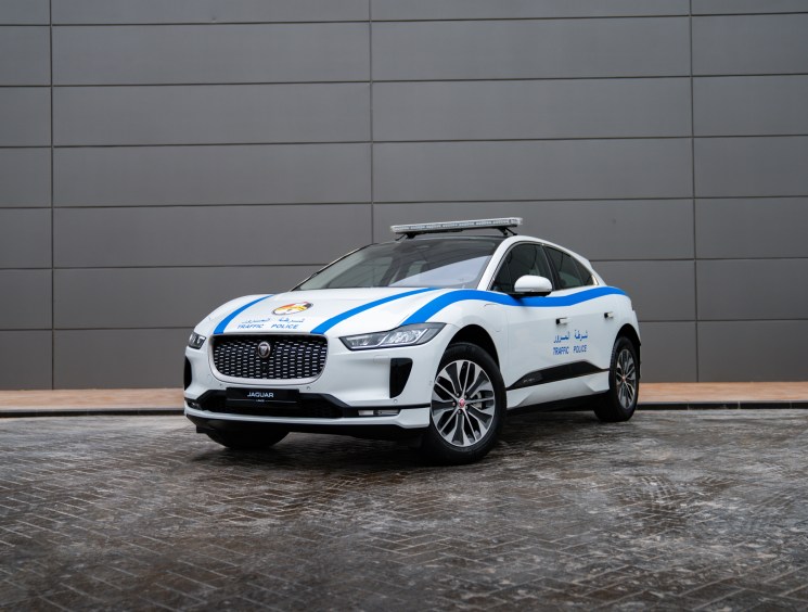 White Jaguar I-Pace electric vehicle with blue police markings and light bar on roof