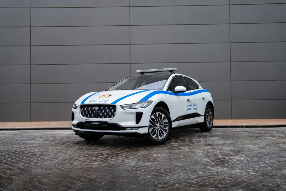 White Jaguar I-Pace electric vehicle with blue police markings and light bar on roof