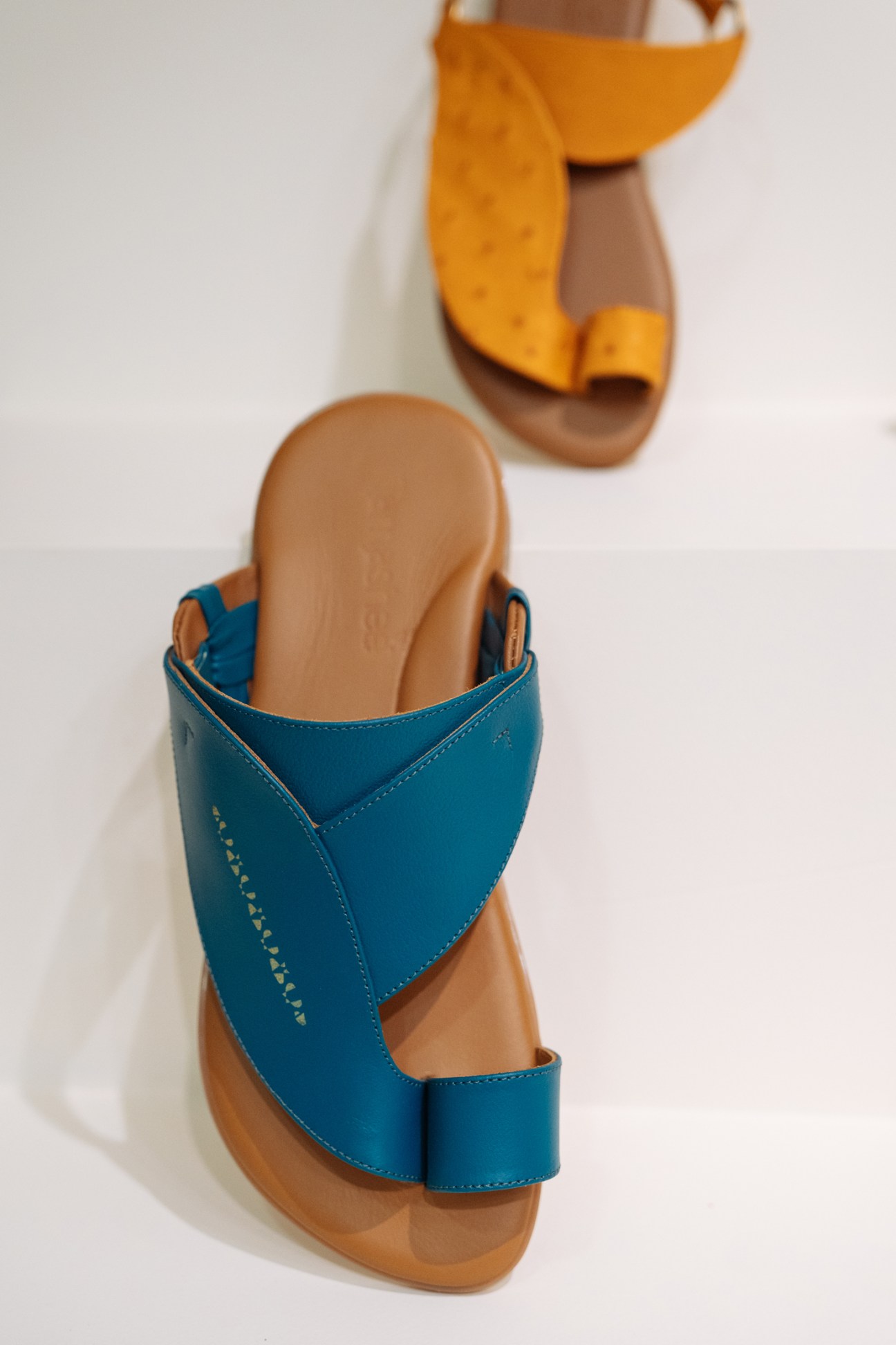 Tamashee sandals in teal and mustard leather with traditional silhouette design.