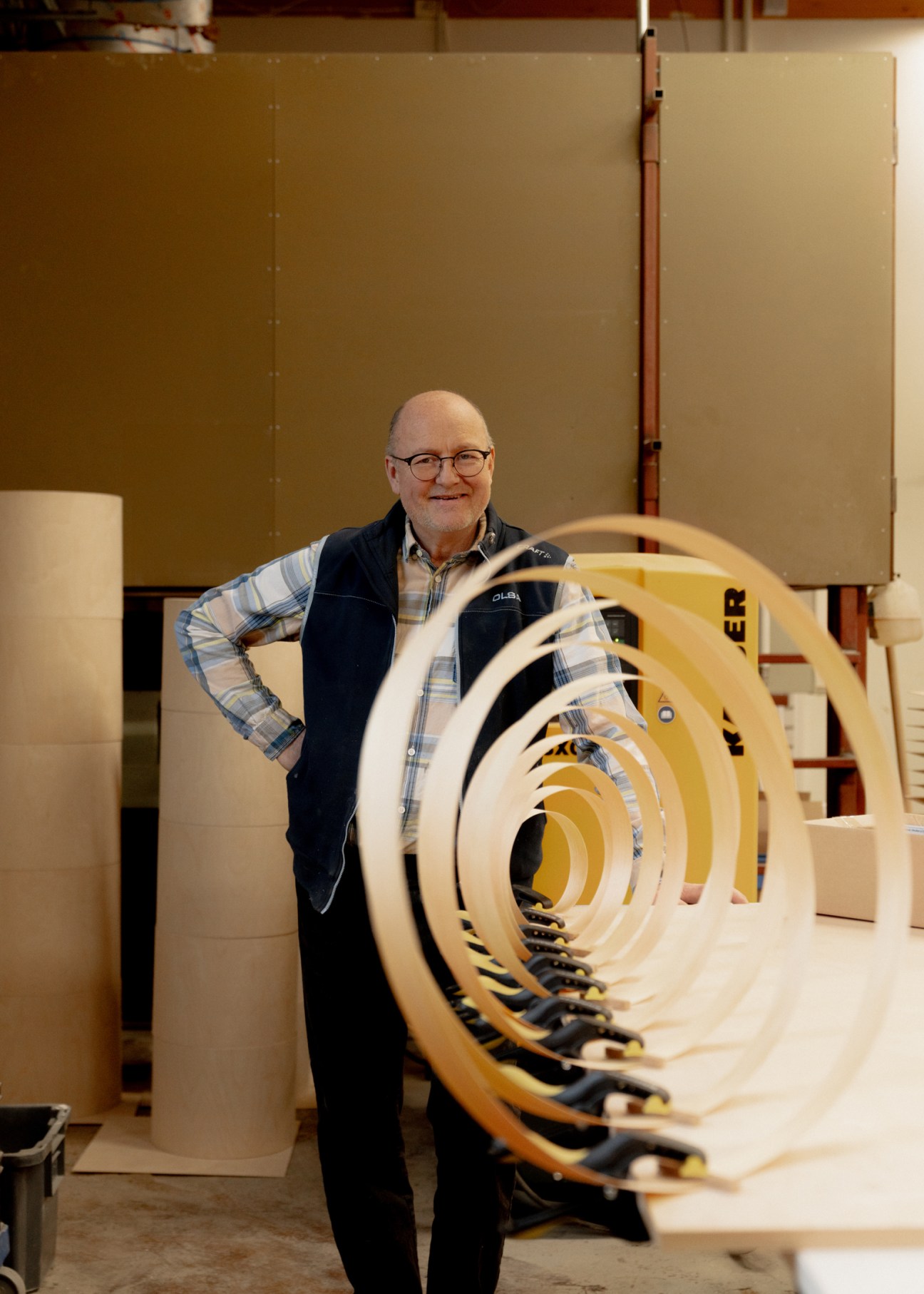 Portrait of lighting maker Heikki Saastamoinen working with pine wood materials