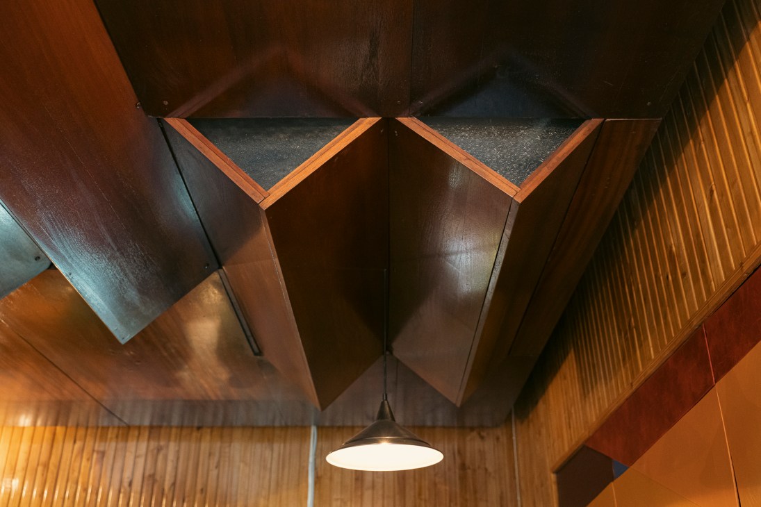 Ornate wooden ceiling with geometric angular patterns and decorative carved details