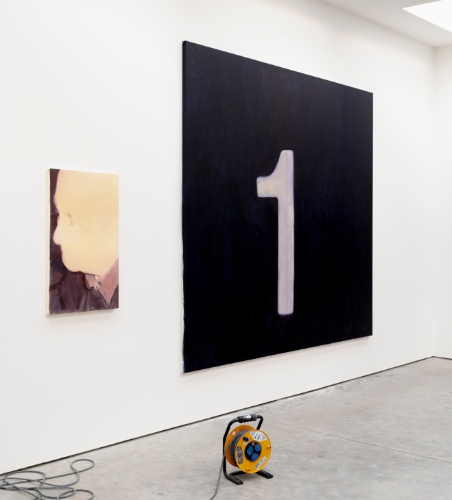 Gallery wall displaying large black canvas with white numeral 1 and smaller abstract painting