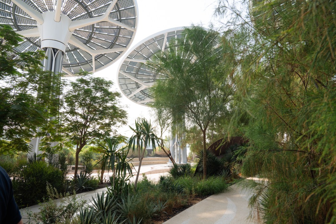 Solar panel structures and lush vegetation at Terra Sustainability Pavilion in Expo City Dubai