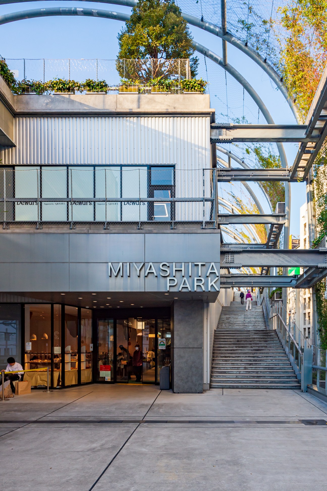 Modern shopping complex entrance with Miyashita Park signage and stairs leading to upper levels