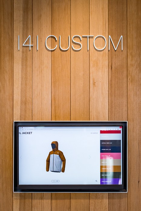 Digital display showing the 141 Custom service for color customization of North Face jackets.