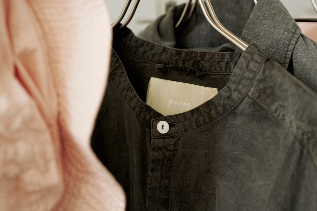 Natural dyeing workspace showing fabric samples and materials for Innat brand clothing production