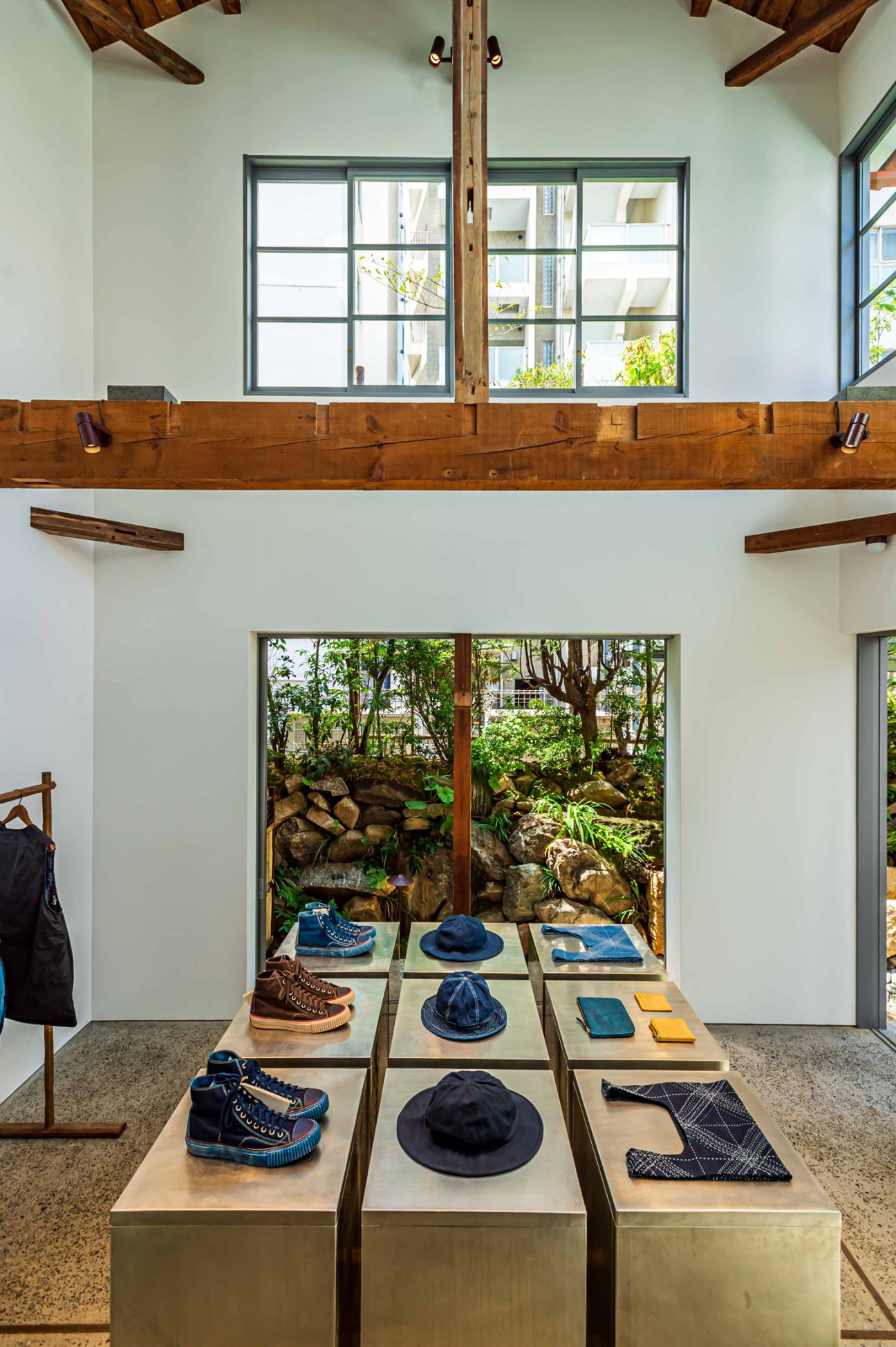 Interior of Visvim General Store showing minimalist retail space with wooden beams and display platforms