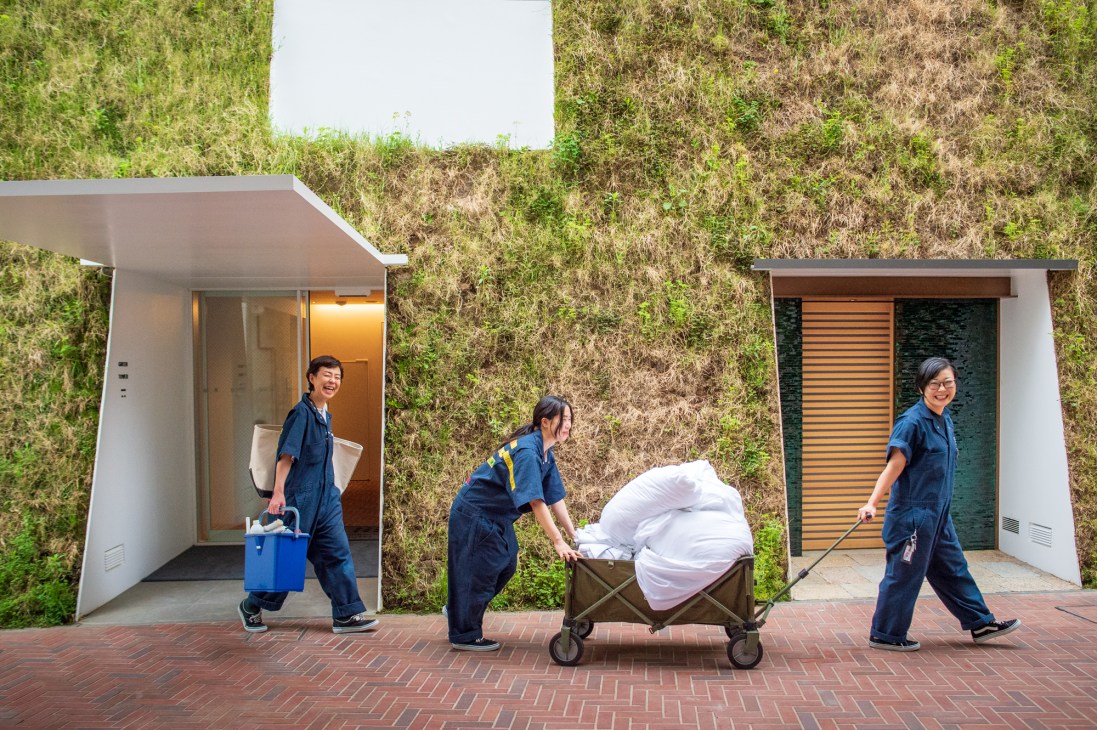 Housekeeping staff in front of Sou Fujimoto's Green Tower building