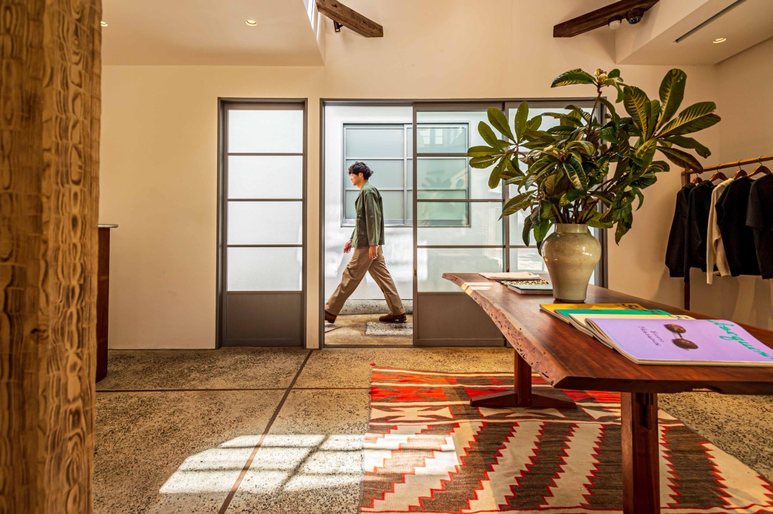 Interior of Visvim General Store in Tokyo showing modern retail space with exposed wooden beams and natural lighting