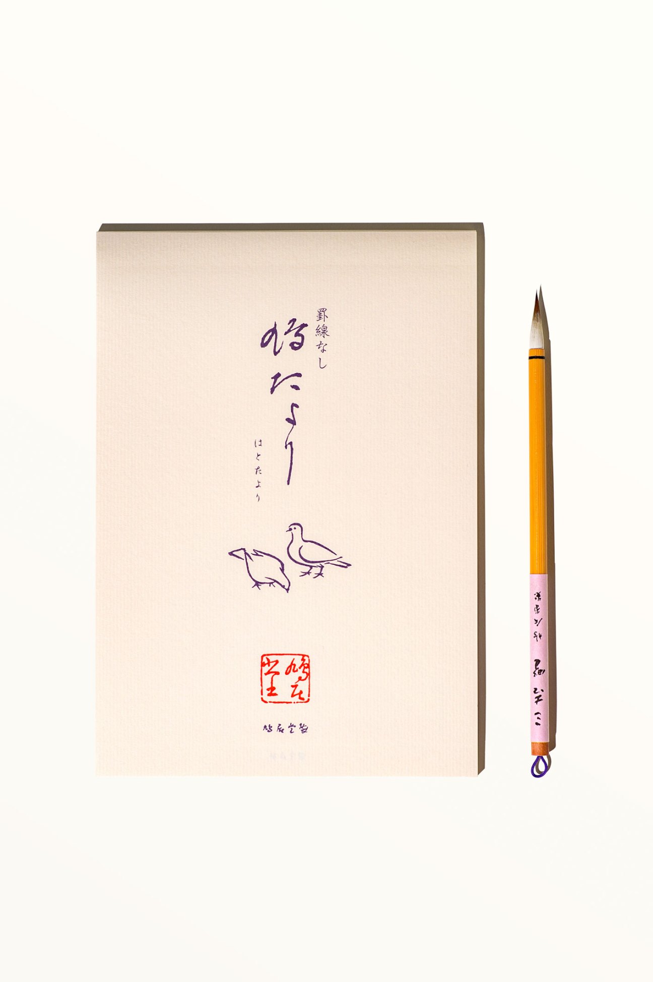 Traditional calligraphy brush and binsen writing paper pad arranged for Japanese writing practice