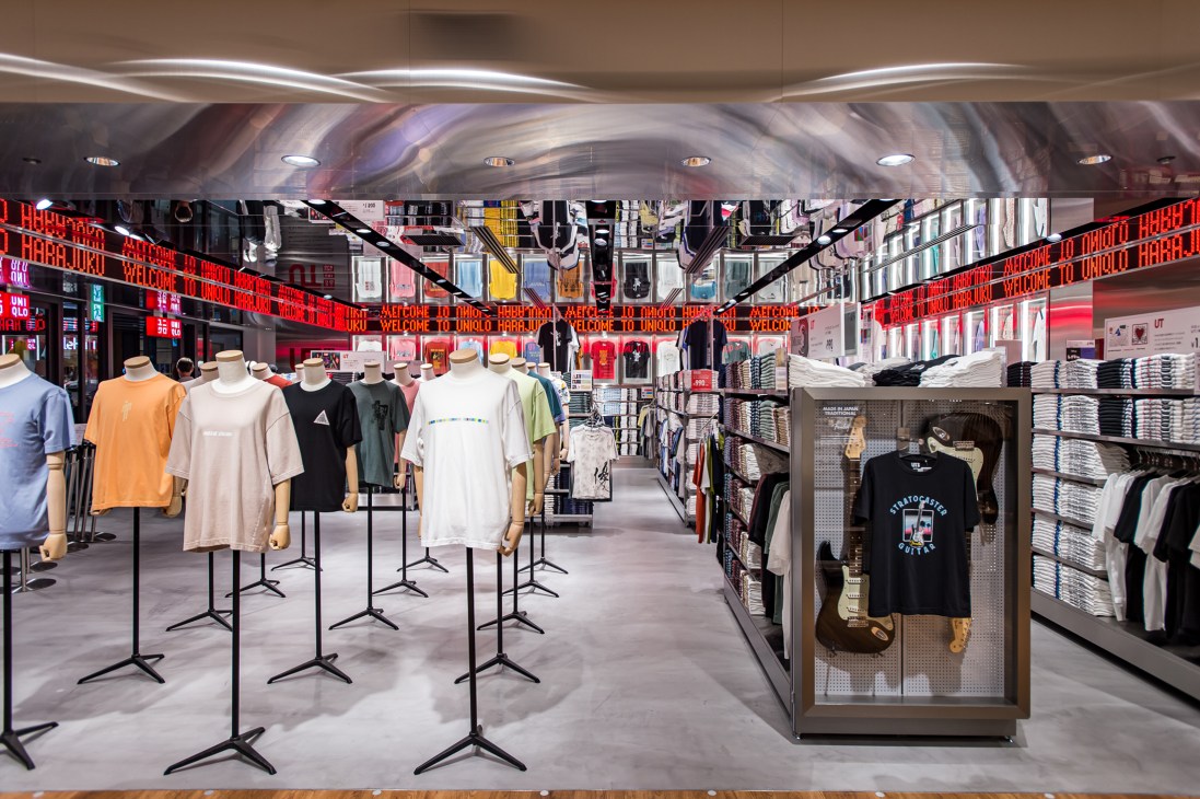 Uniqlo Harajuku store interior with t-shirts on display stands and neon signage