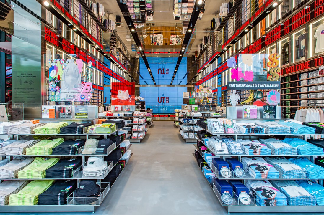 Interior of Uniqlo Harajuku store with colorful UT t-shirt displays and vibrant signage.