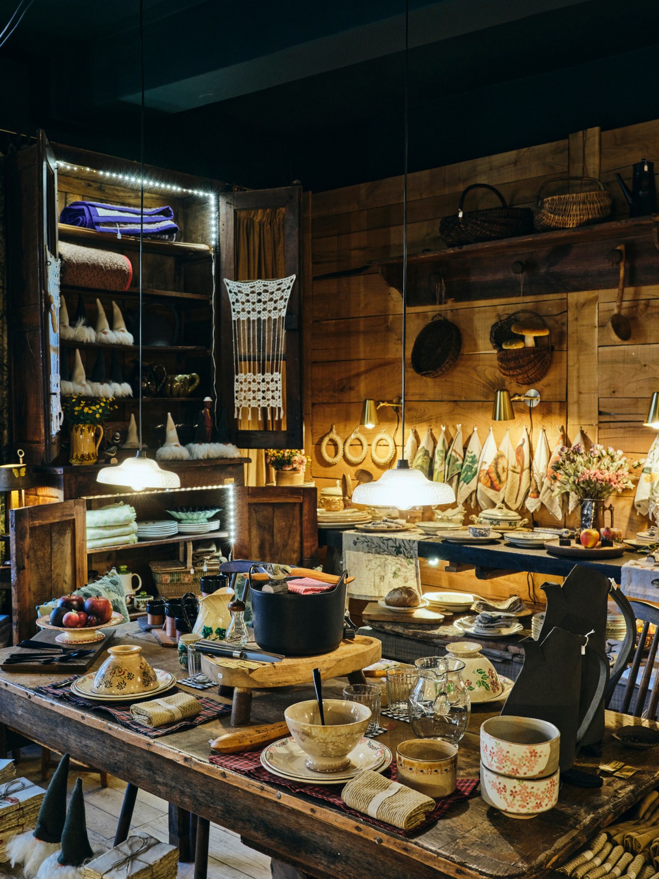 Rustic interior of De La Luce homeware boutique showing wooden shelving, wicker baskets, ceramics and vintage items
