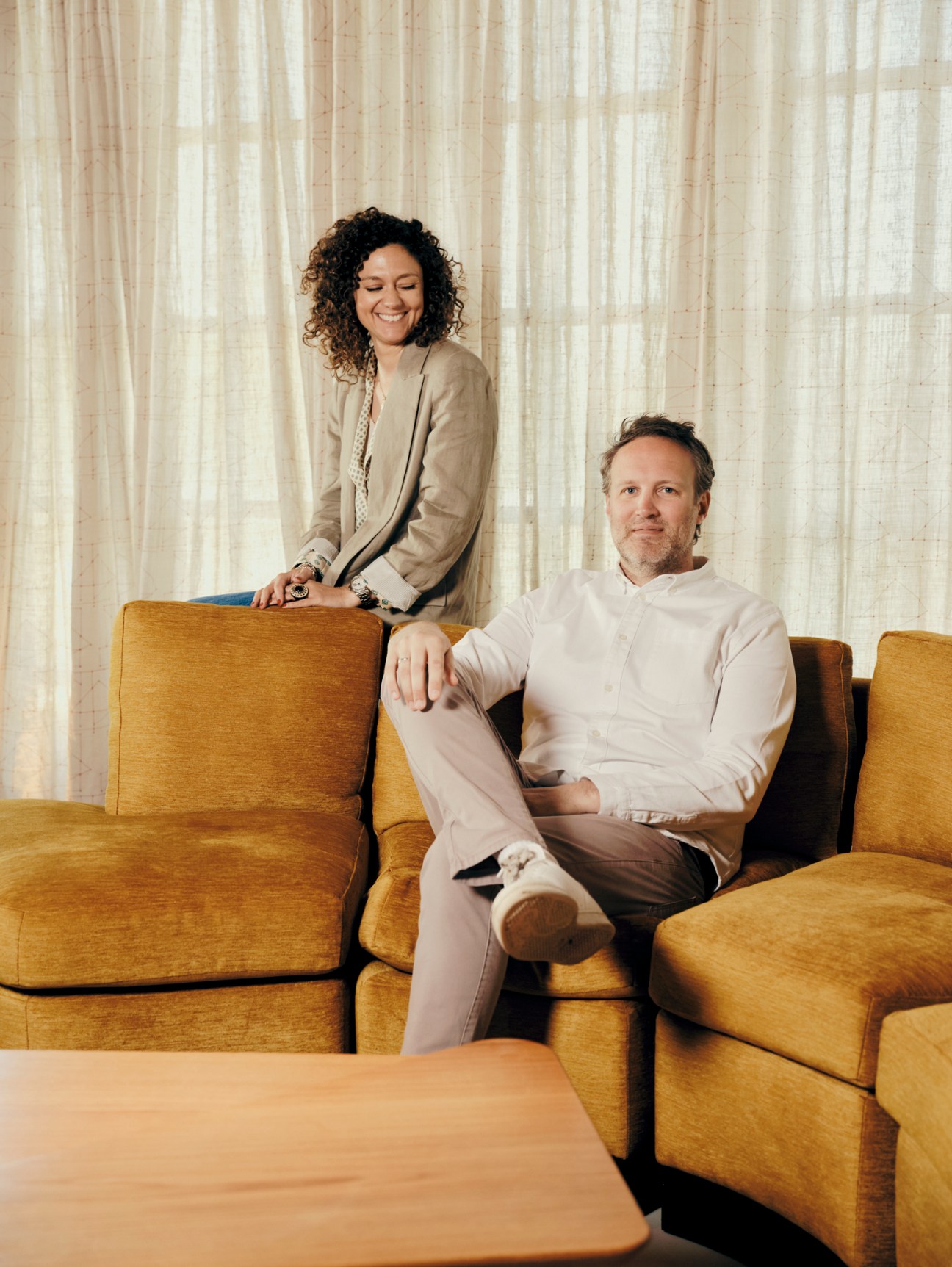 Clémence Pirajean and James Michael Lees, two designers standing together in an elegant interior space
