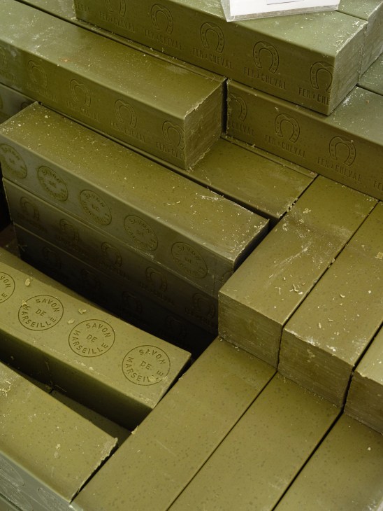 Stacked bars of Fer à Cheval soap with embossed branding and circular stamps.