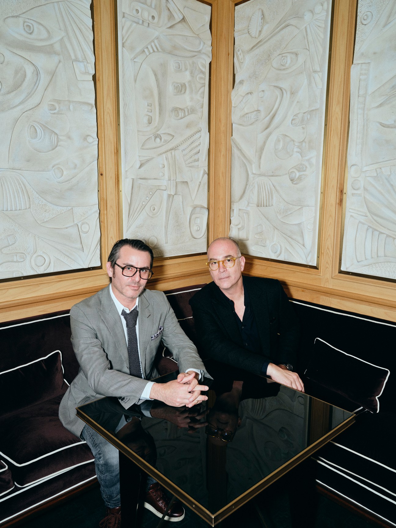 Yoram Roth and Josh Wyatt sitting at a table in an upscale interior with decorative wall panels