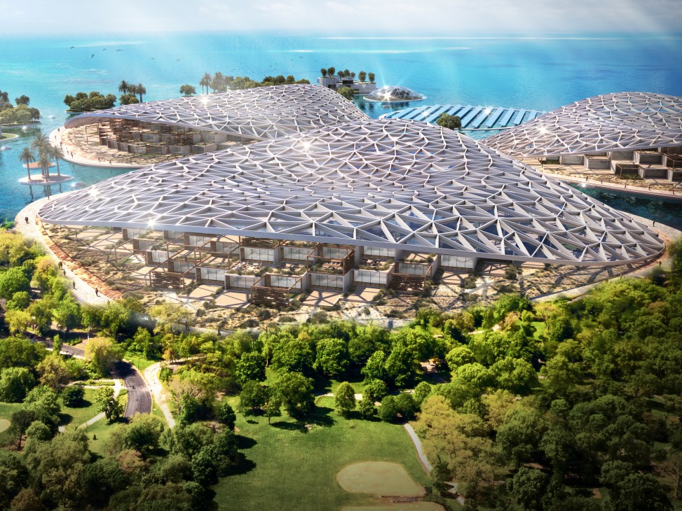 Aerial rendering of Dubai Reefs sustainable floating community with distinctive patterned roofs overlooking turquoise waters and surrounding green landscape.