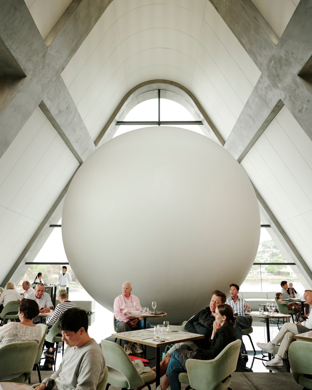 James Turrell's 'Unseen Seen' installation featuring a large white sphere in a restaurant with diners seated at tables