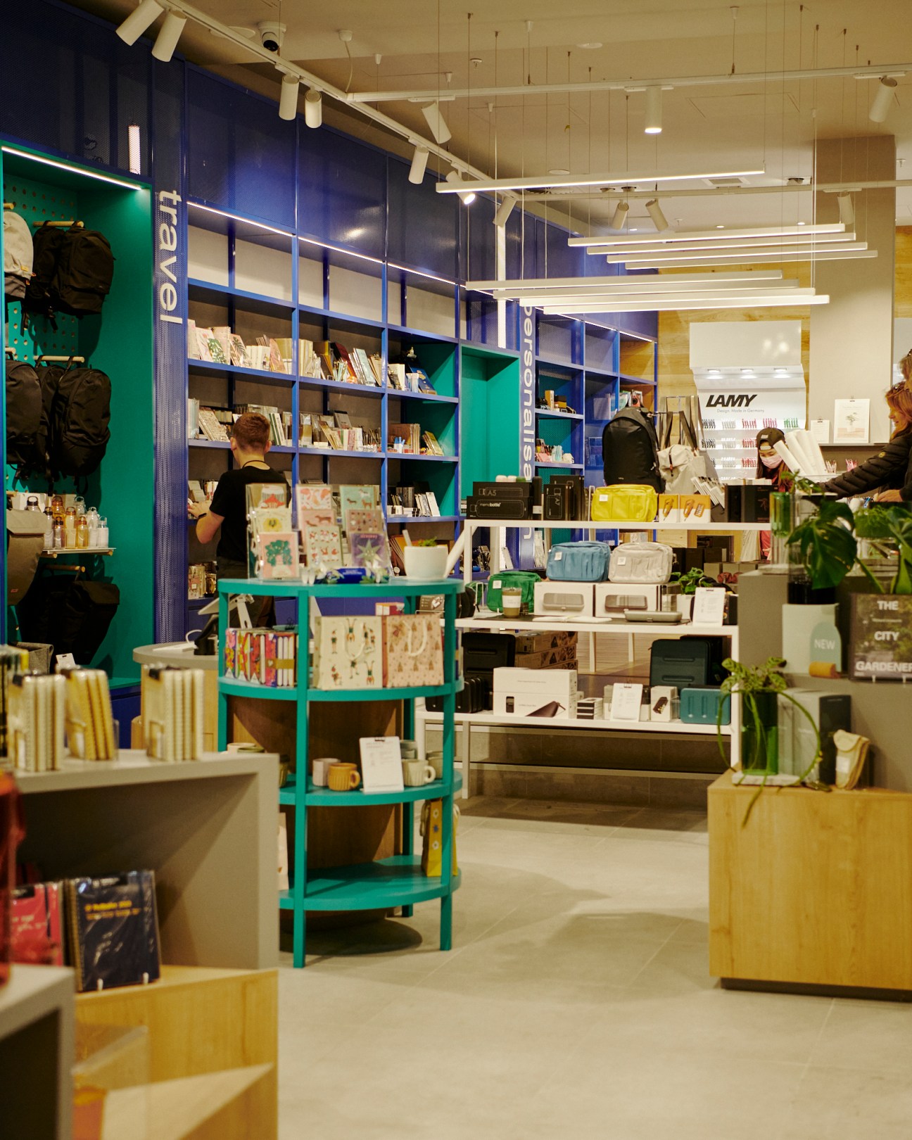 Milligram's bright interior showing aqua and powder-blue shelving with organized stationery displays