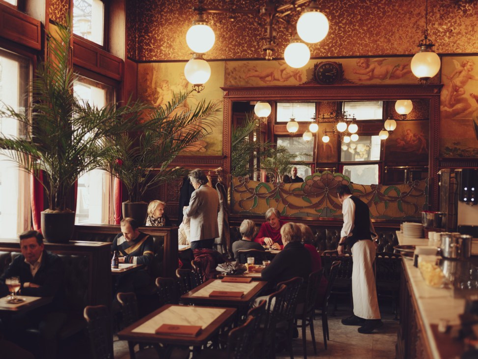 Interior of a traditional restaurant in Leuven, Belgium with warm lighting and classic decor