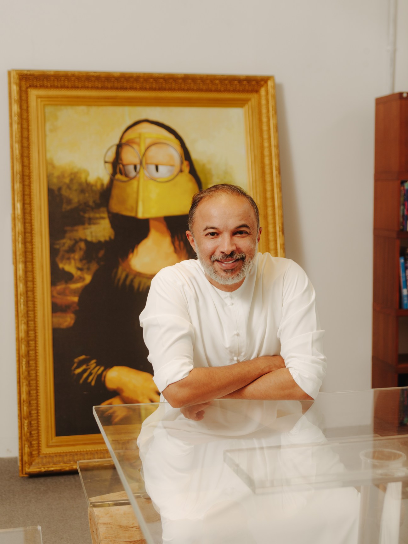 Mohammed Saeed Harib smiles at Lammtara Studio with a Freej character portrait behind him.