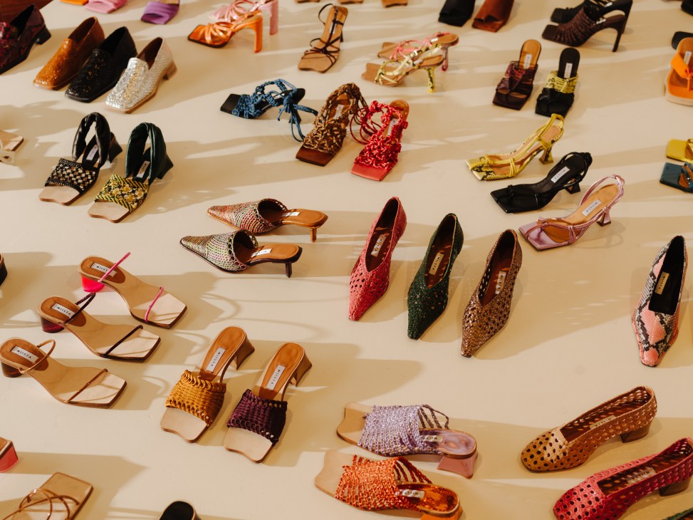 Colorful women's shoes displayed on a light wooden floor in Miista's Bethnal Green retail space