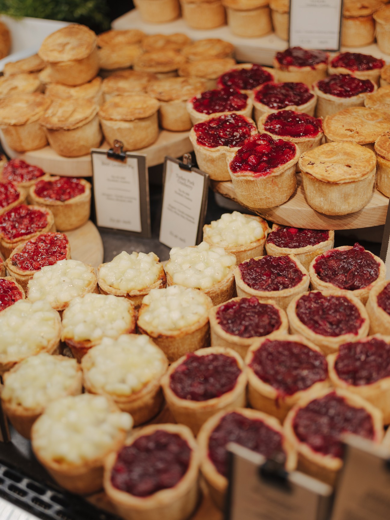 Assorted pies with cranberry and cream toppings displayed at Gloucester Services.