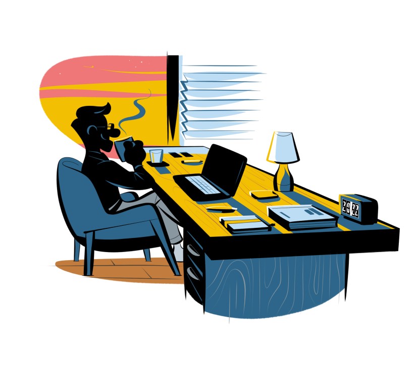 Person working at desk with laptop during late hours, with warm lighting and air conditioning visible