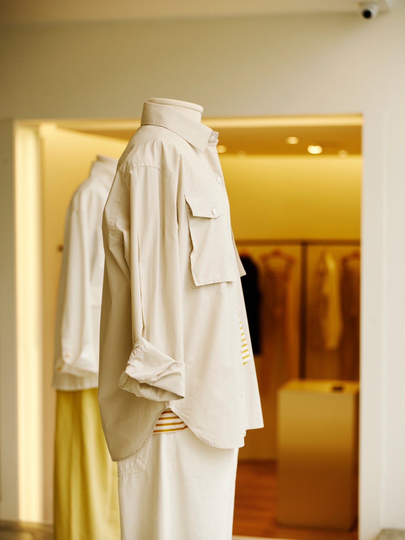 Clean minimalist clothing display at Egrey showing simple silhouettes in neutral tones