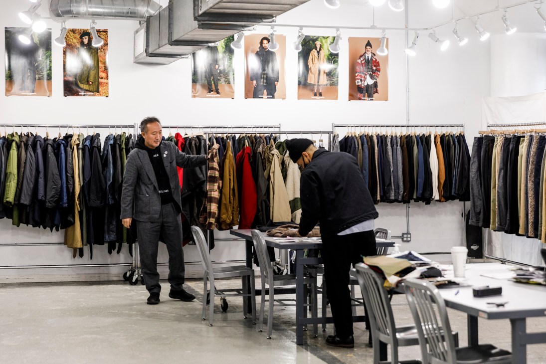 Daiki Suzuki working with staff at the Engineered Garments shop in New York