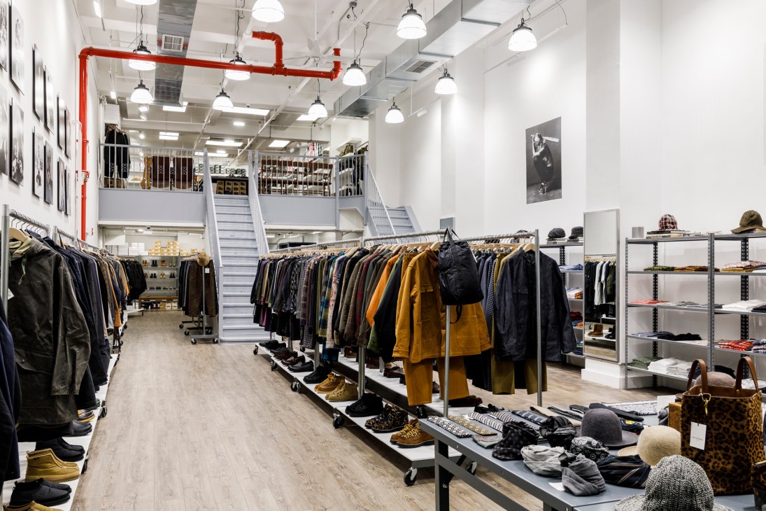 Interior of Nepenthes shop displaying clothing racks with jackets and accessories in a modern retail space