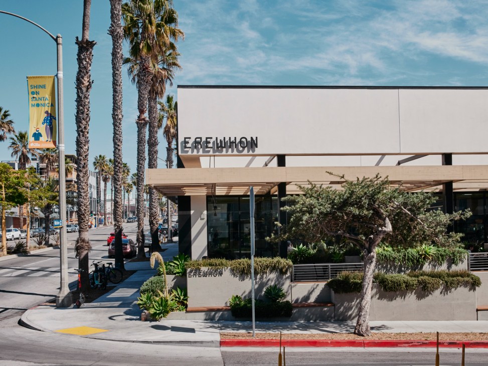 Modern Erewhon grocery store exterior with palm trees and glass windows in Santa Monica