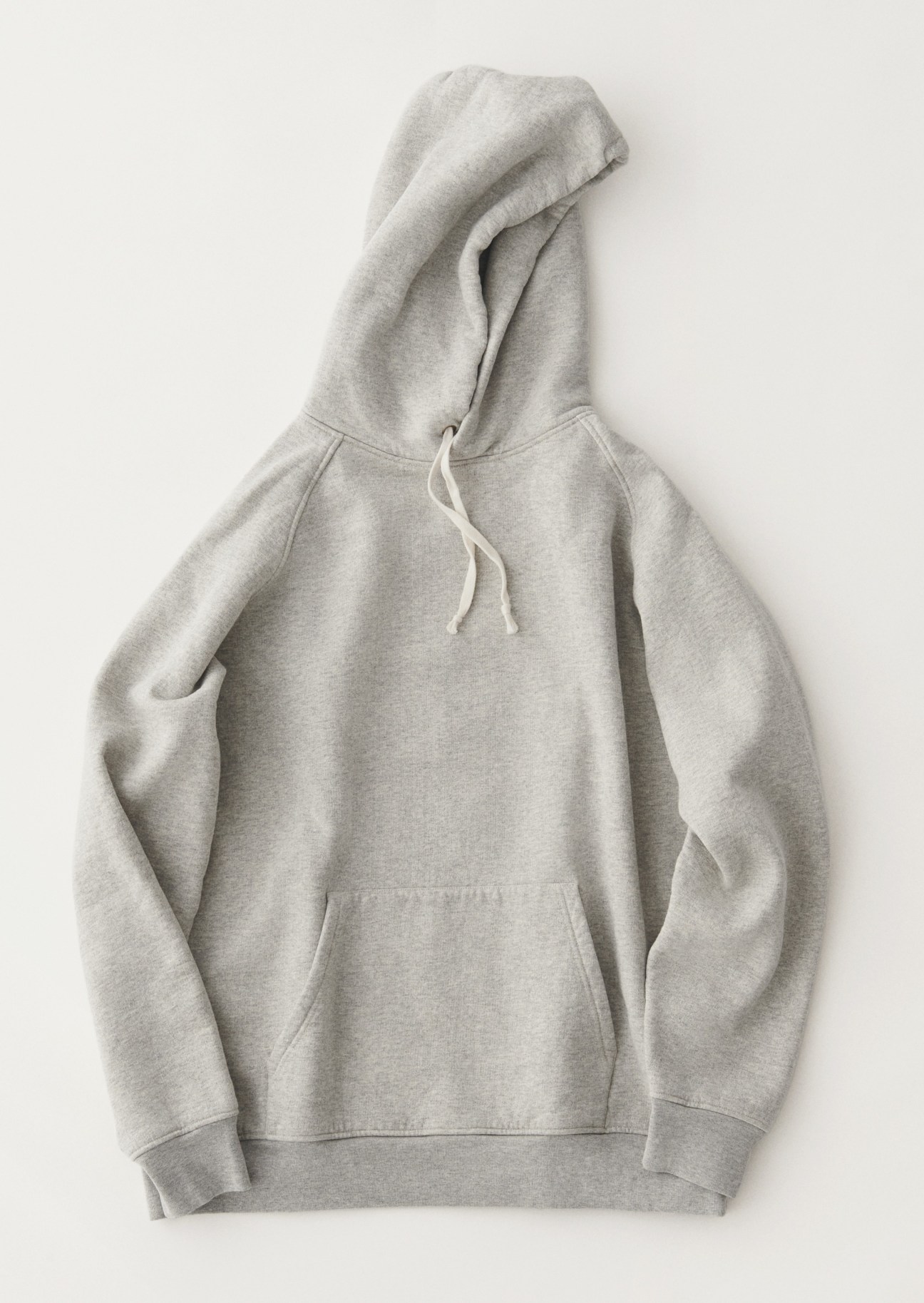 Grey hooded sweatshirt laid flat against white background