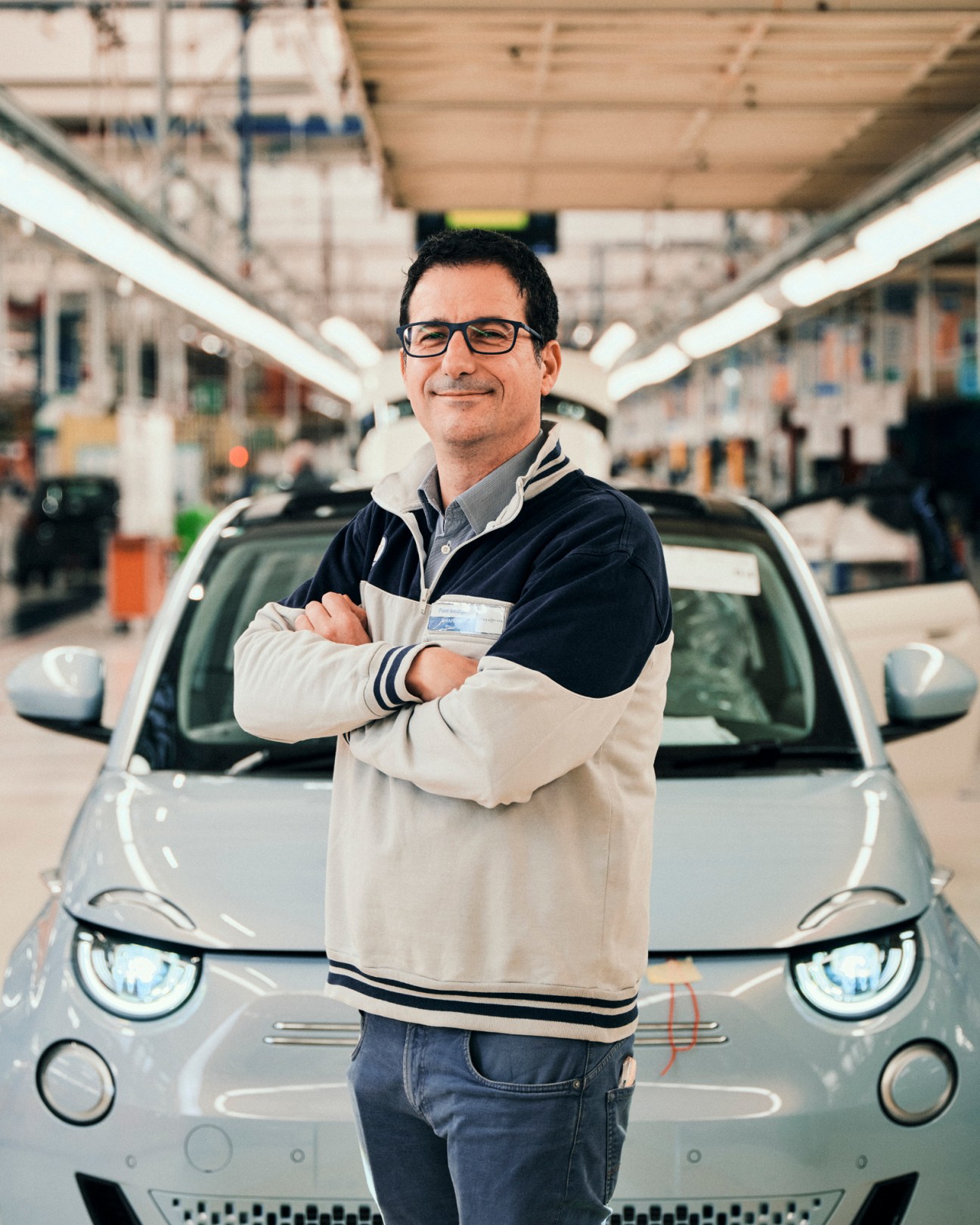 Luigi Barbieri, assembly plant manager, stands with arms crossed in Fiat's manufacturing facility.