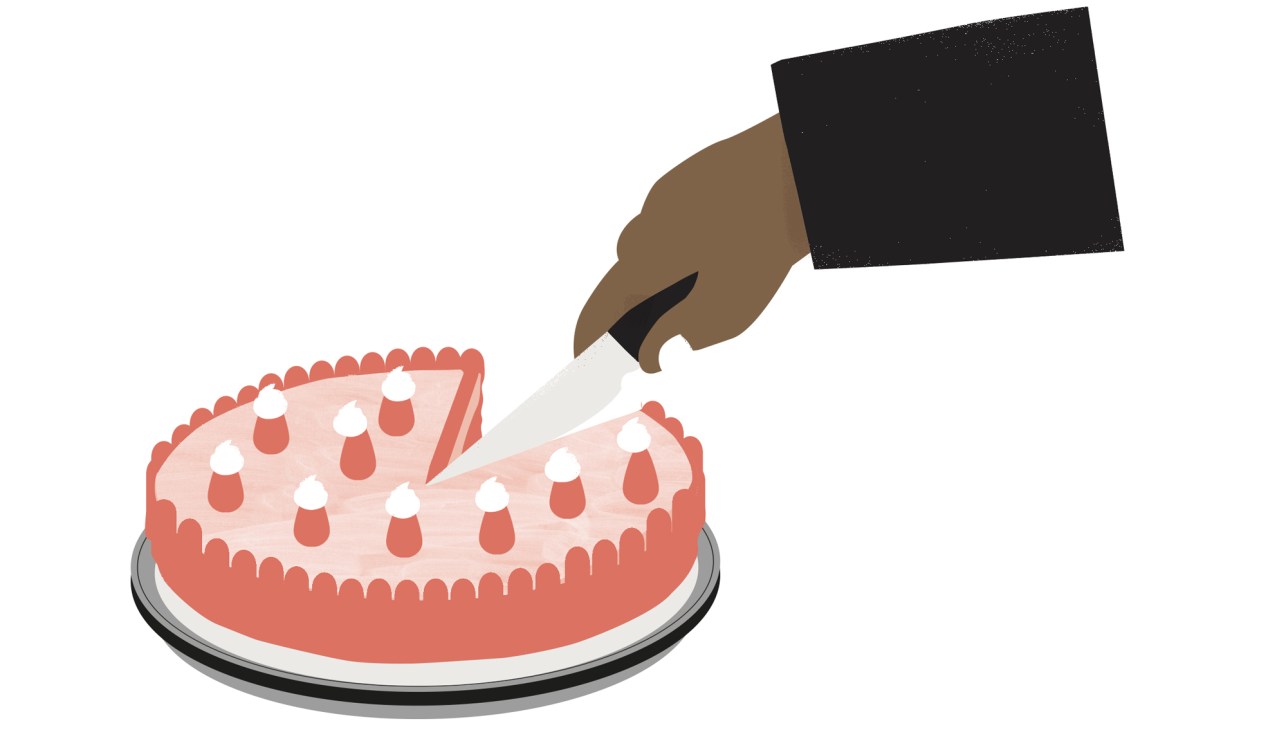 Hand cutting a slice from a pink decorated cake on a white plate