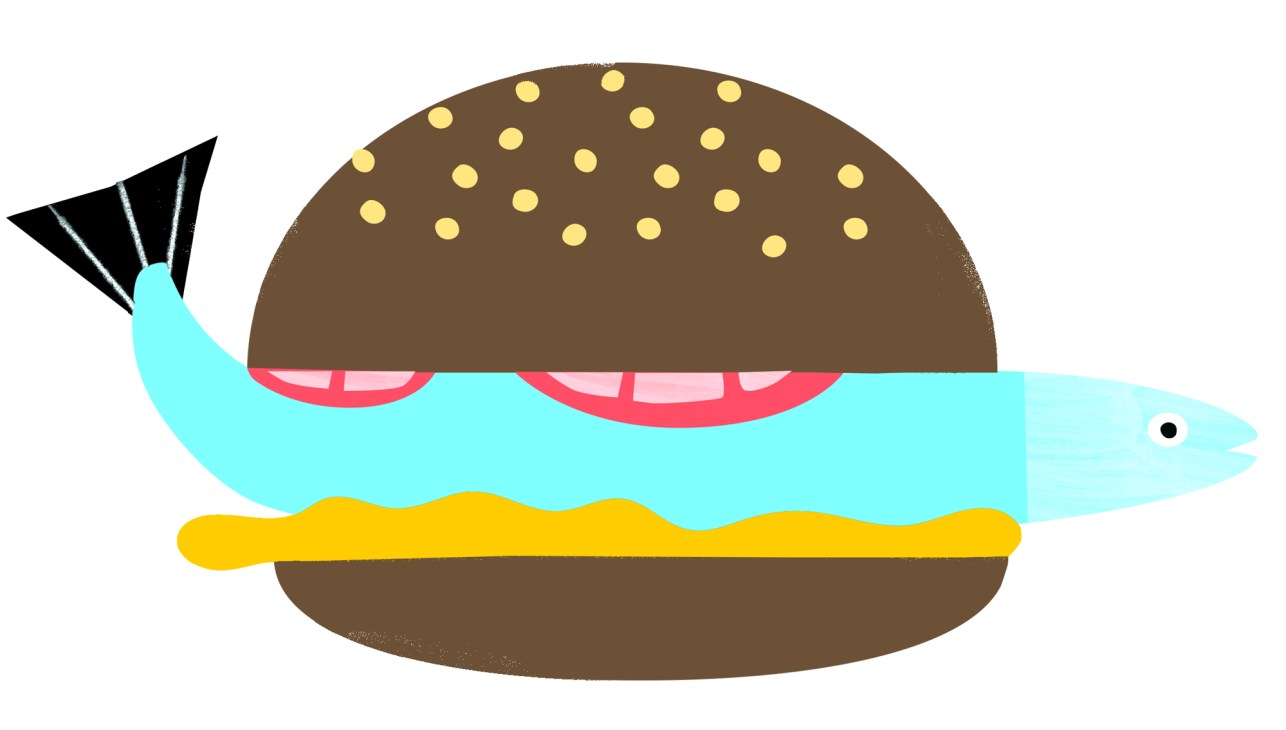 Pike burger served on a wooden board with sides
