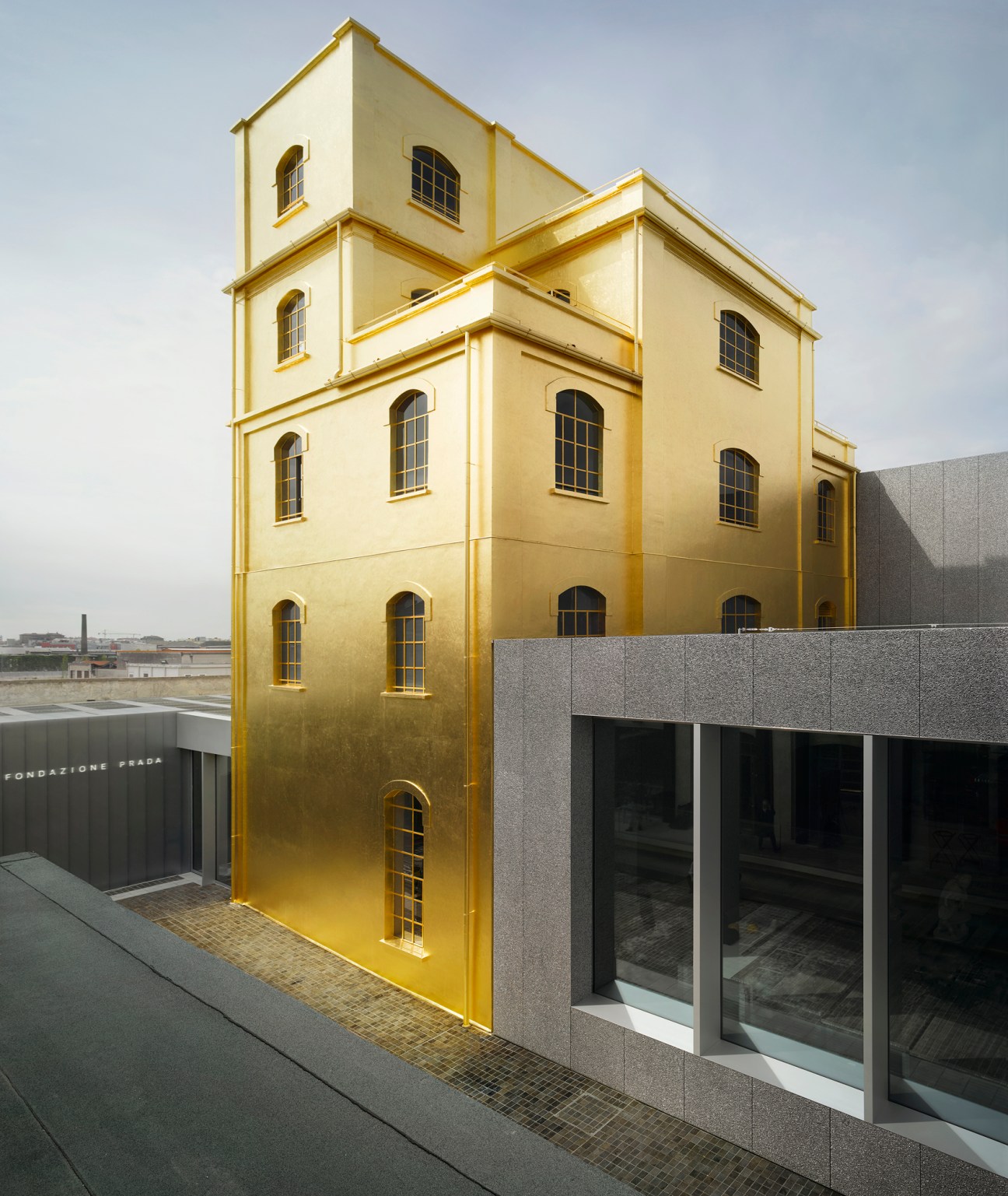 Fondazione Prada's gilded tower structure in Milan, a 1910s haunted house exterior covered in 24-carat gold leaf.