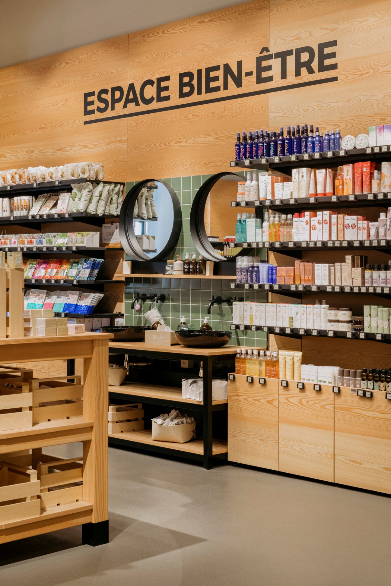 Beauty and wellness products displayed on wooden shelves in upmarket retail store